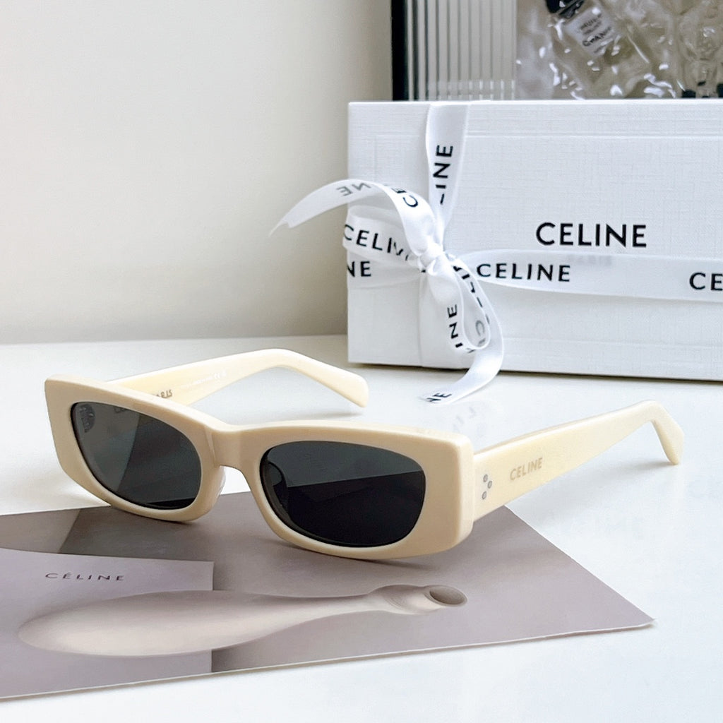 Celine sunglasses, cream frame with dark lenses, full-rim cat-eye style.