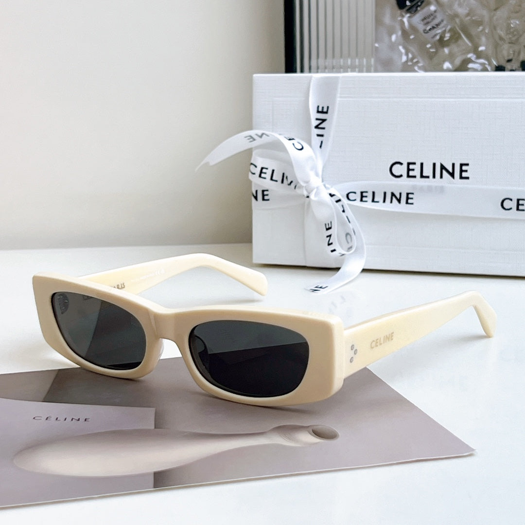 Celine sunglasses, cream frame with dark lenses, full-rim cat-eye style.