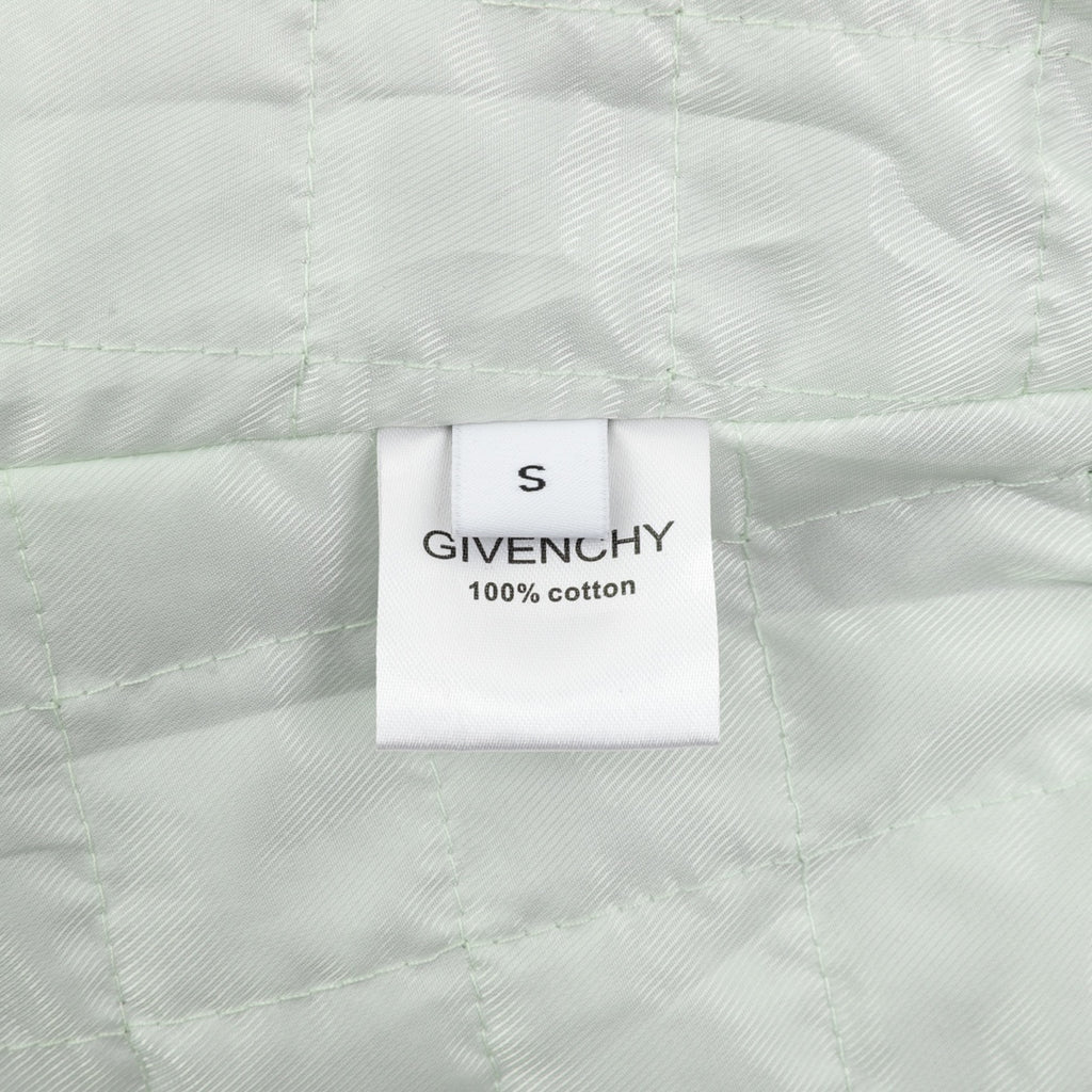 White fabric label reading size S and 100% cotton