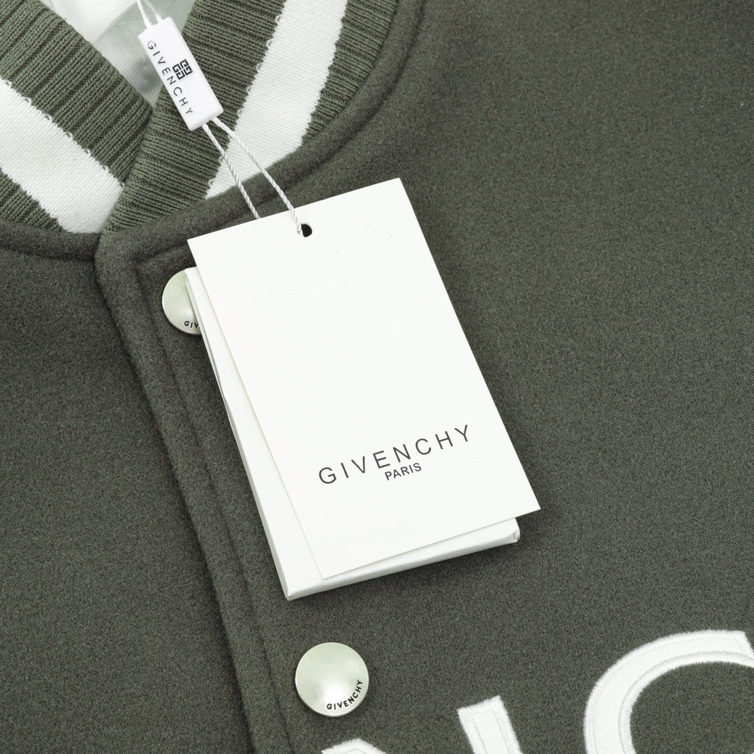 Dark green jacket with ribbed collar, snap buttons, and attached tag
