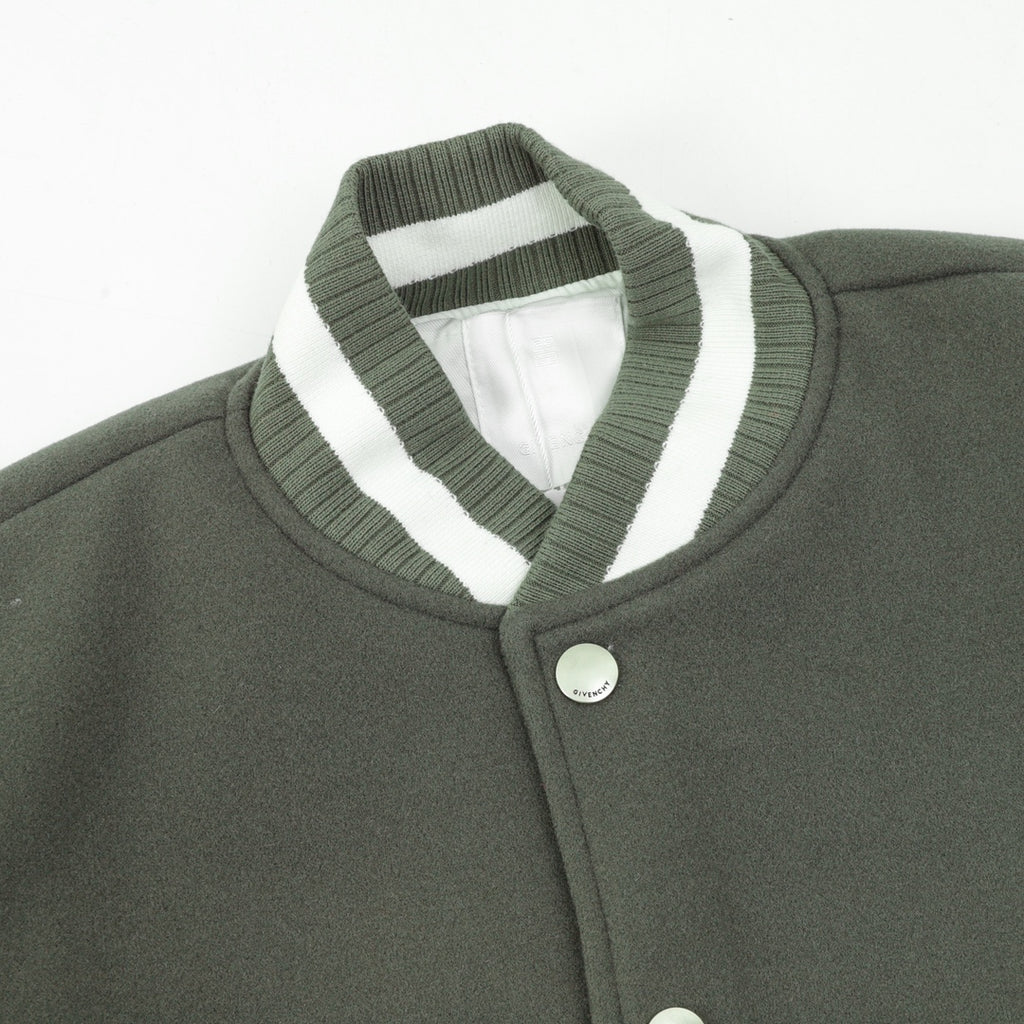 Dark green jacket collar with white striped trim and snap button