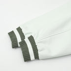 White sleeve fabric with dark ribbed cuff and striped trim
