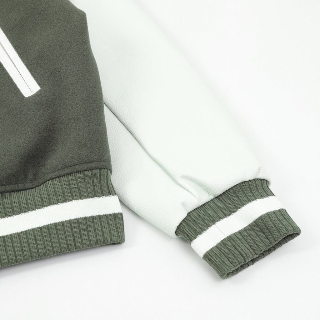 Dark green and white striped ribbed sleeve cuff on varsity jacket