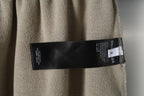 Beige pants with woven Balenciaga brand label on inner waistband