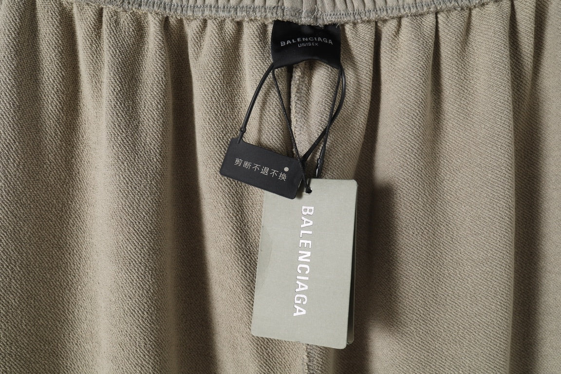 Beige pants waistband with Balenciaga hang tag and size label