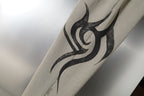 Beige pants with black flame graphic print on the fabric.