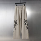 Balenciaga beige wide-leg pants with black flame graphic on both legs