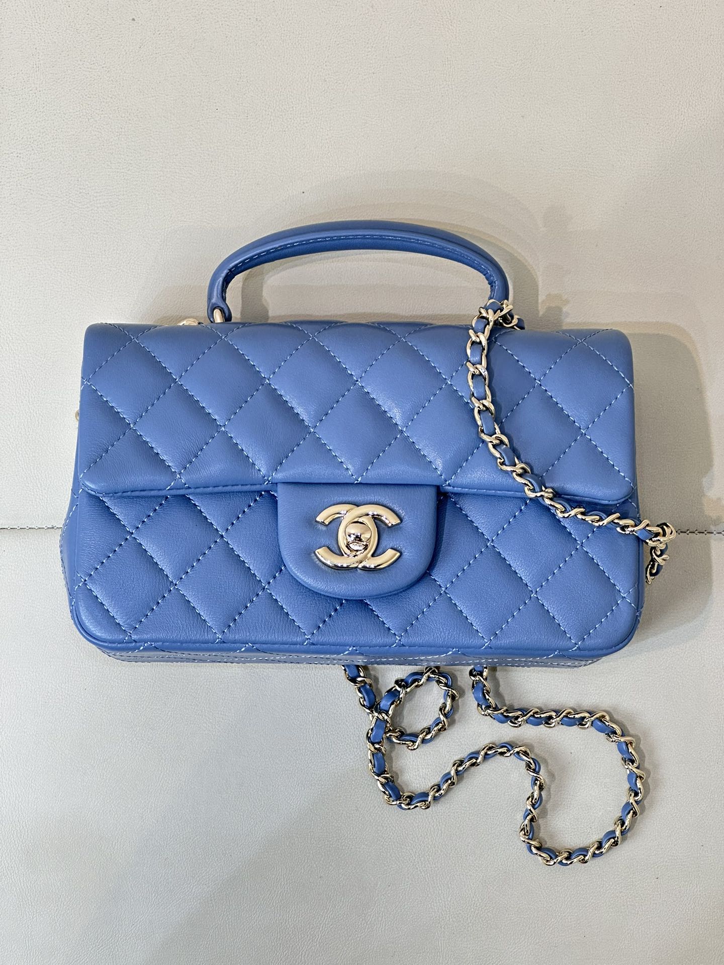 Chanel blue quilted flap handbag with gold CC logo and long chain shoulder strap