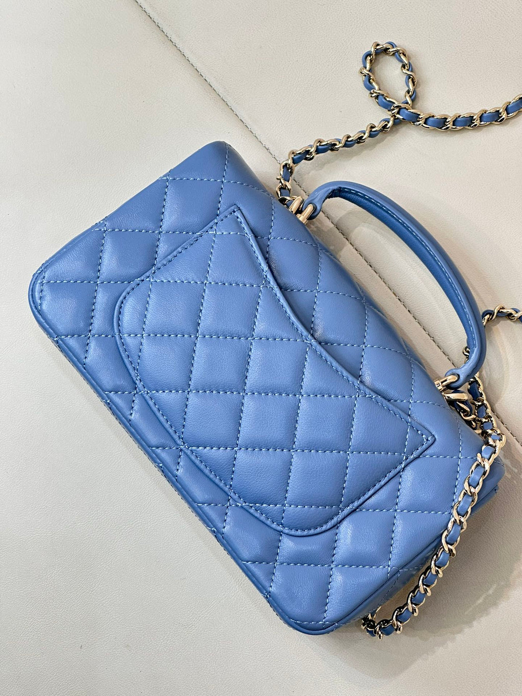 Chanel blue quilted shoulder bag with flap and chain strap, angled view