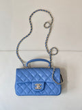 Chanel blue quilted shoulder bag with flap, gold logo, and silver chain strap