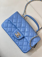 Chanel blue quilted shoulder bag with flap, chain strap, and open top view