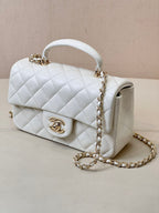 Chanel white quilted mini handbag with chain strap and curved white top handle