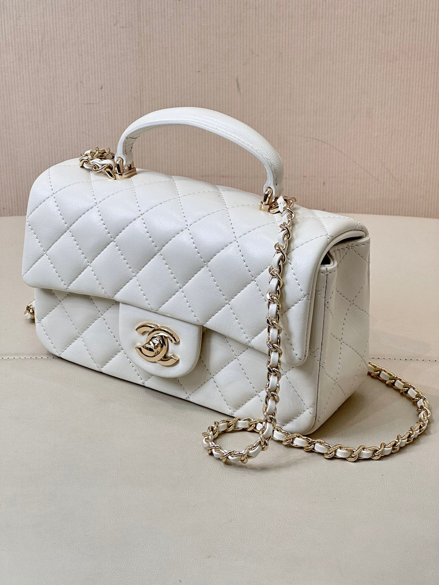 Chanel white quilted mini handbag with chain strap and curved white top handle
