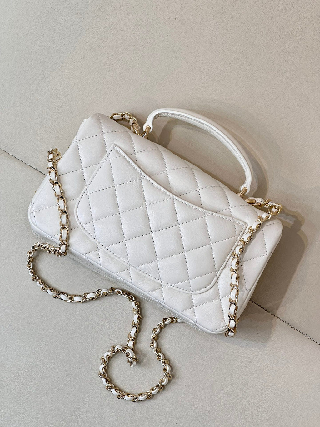 Chanel white quilted mini handbag with gold-tone chain strap and logo front panel