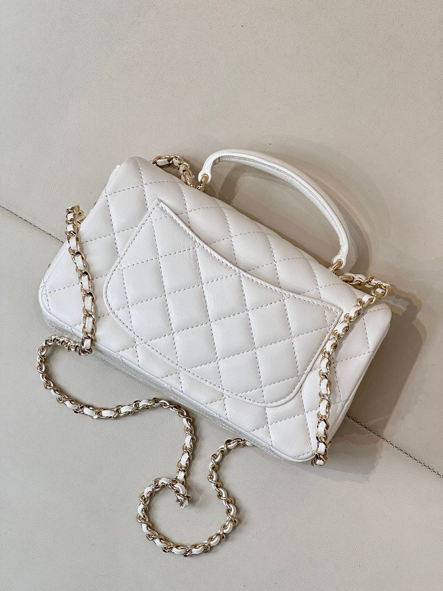 Chanel white quilted mini handbag with gold-tone chain strap and logo front panel