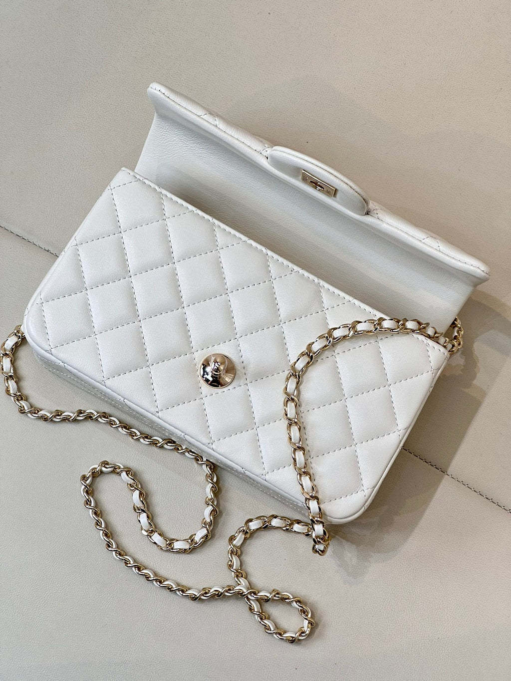 Chanel white quilted mini handbag with chain strap and front flap logo detail