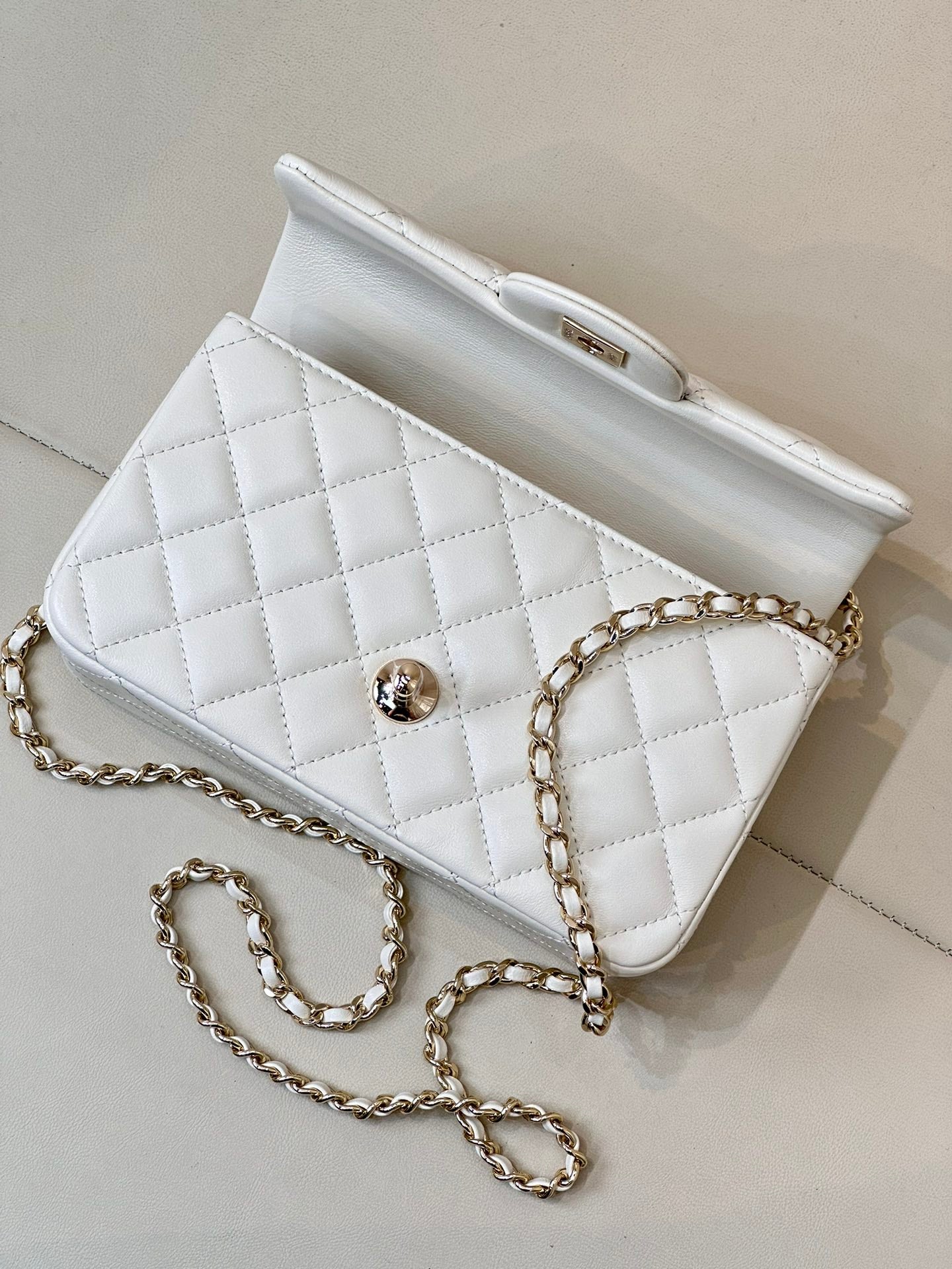 Chanel white quilted mini handbag with chain strap and front flap logo detail