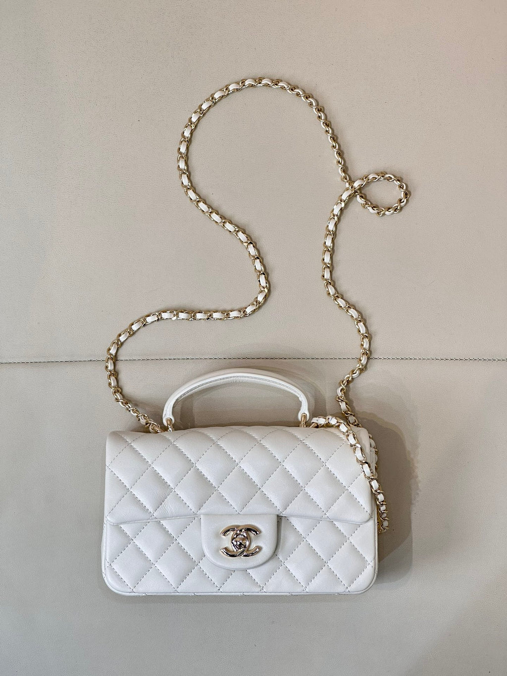 Chanel quilted white mini handbag with chain strap and flap front logo clasp