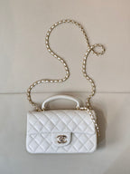 Chanel quilted white mini handbag with chain strap and flap front logo clasp