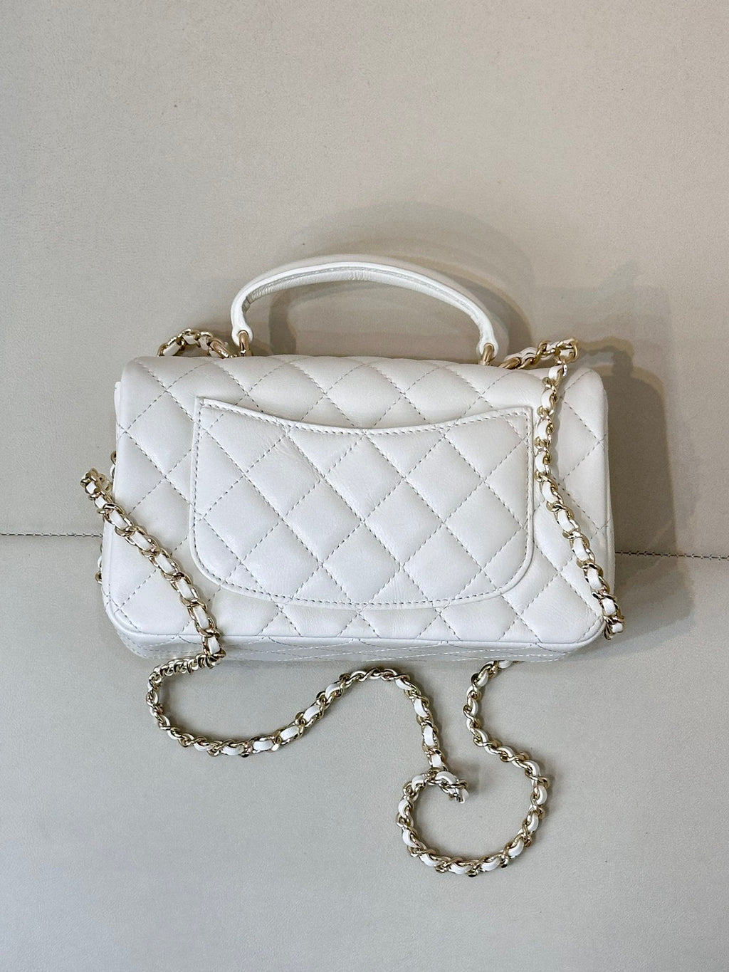 Chanel white quilted mini handbag with chain crossbody strap and top handle