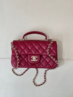 Chanel quilted flap bag with chain strap and top handle, maroon-pink leather