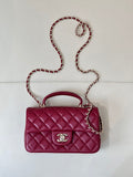 Chanel quilted flap bag with chain strap, maroon-pink leather and top handle