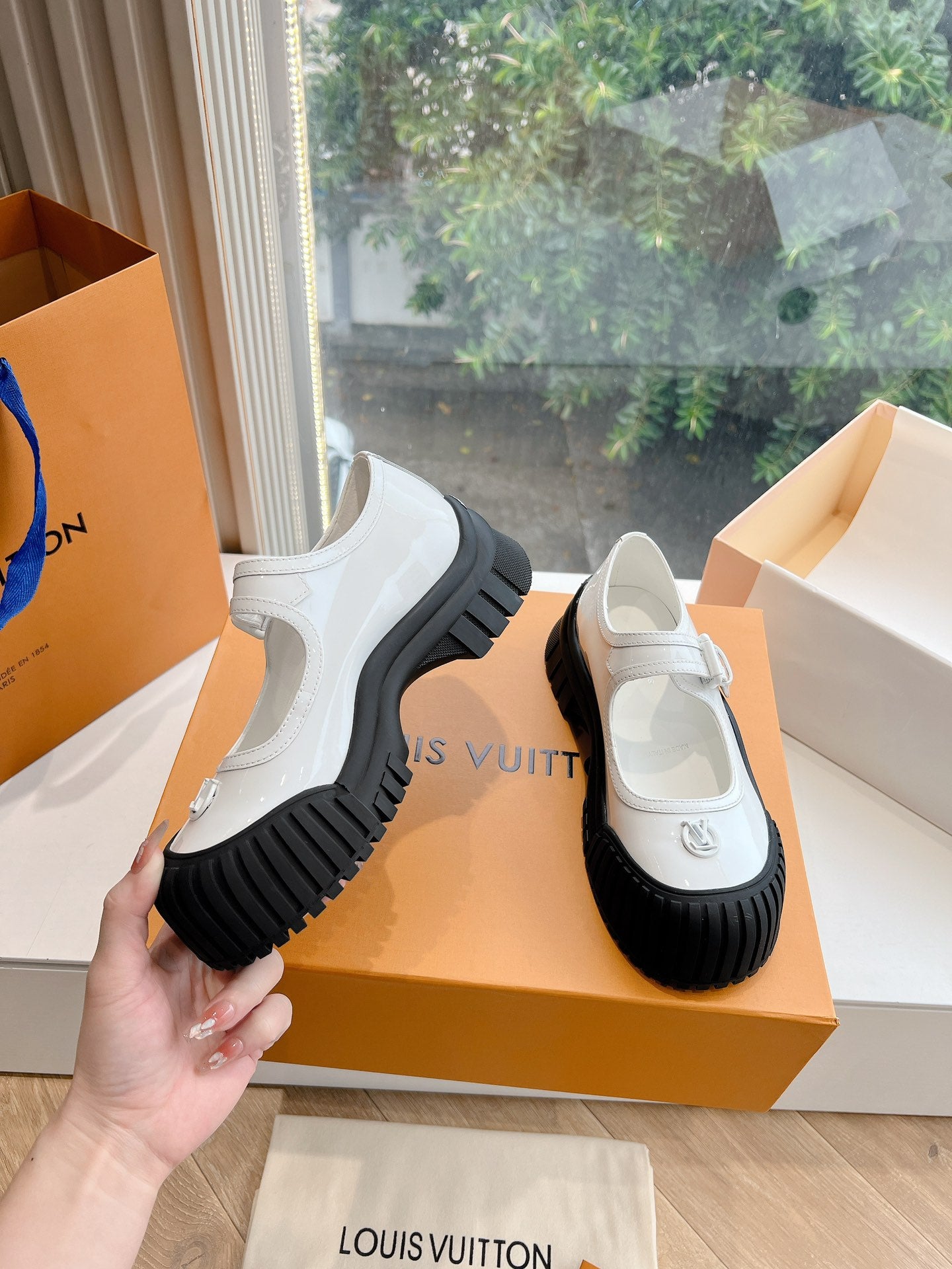 White and black Louis Vuitton unisex sneakers, side view with thick rubber sole