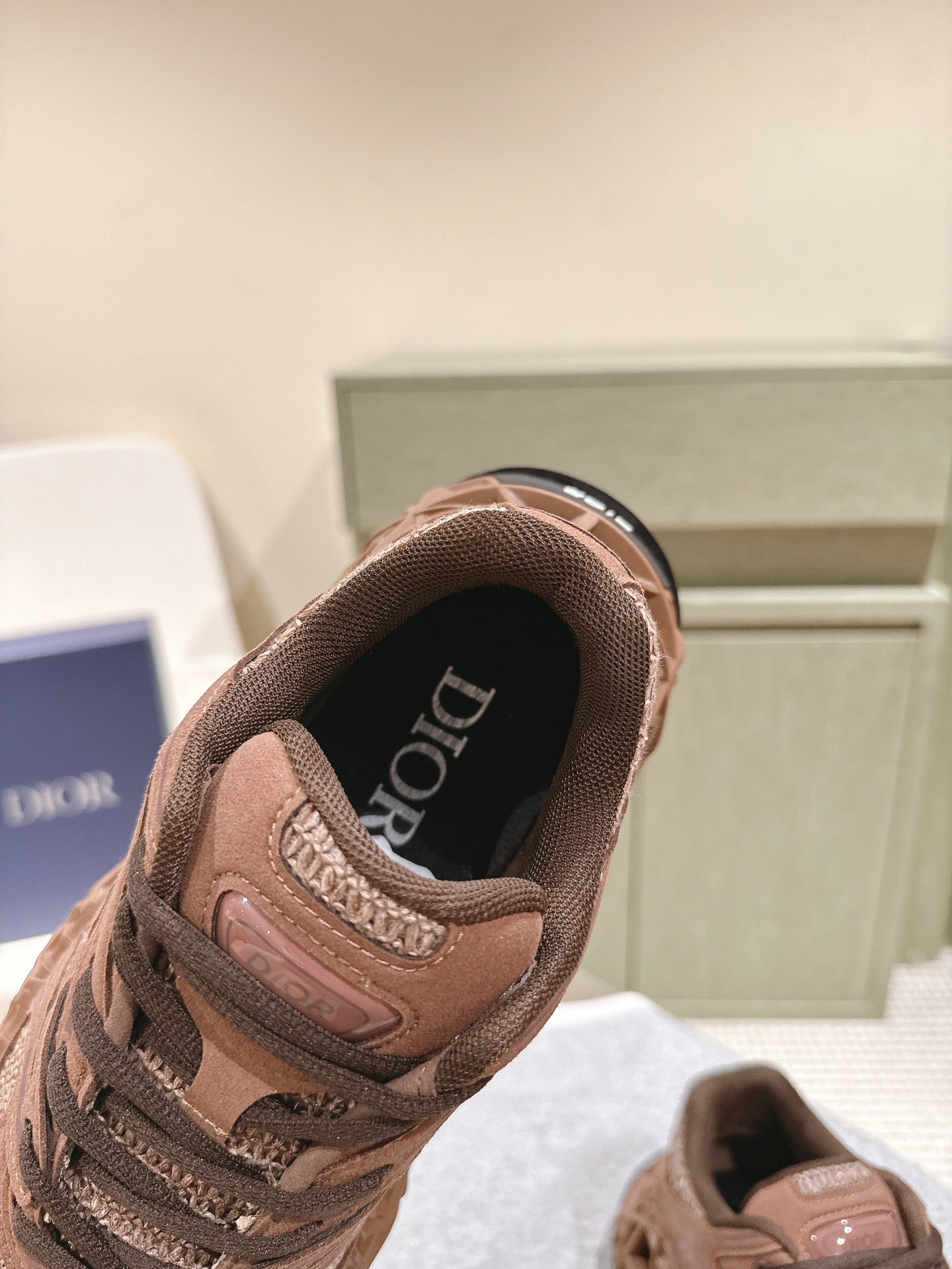 Unisex sneakers heel view with dark lining and DIOR logo on insole