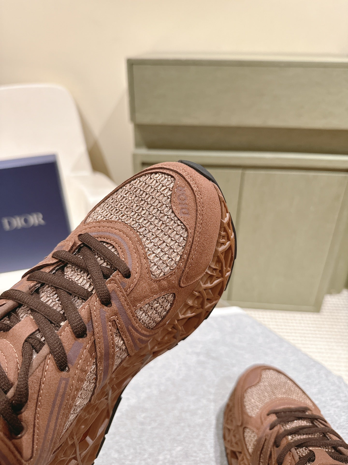 Unisex sneaker side view in tan mesh with brown overlays and lace closure