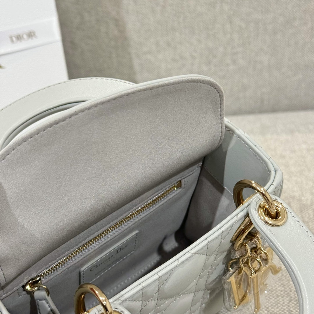 Dior bag open view: white quilted interior with zip pocket and gold zipper