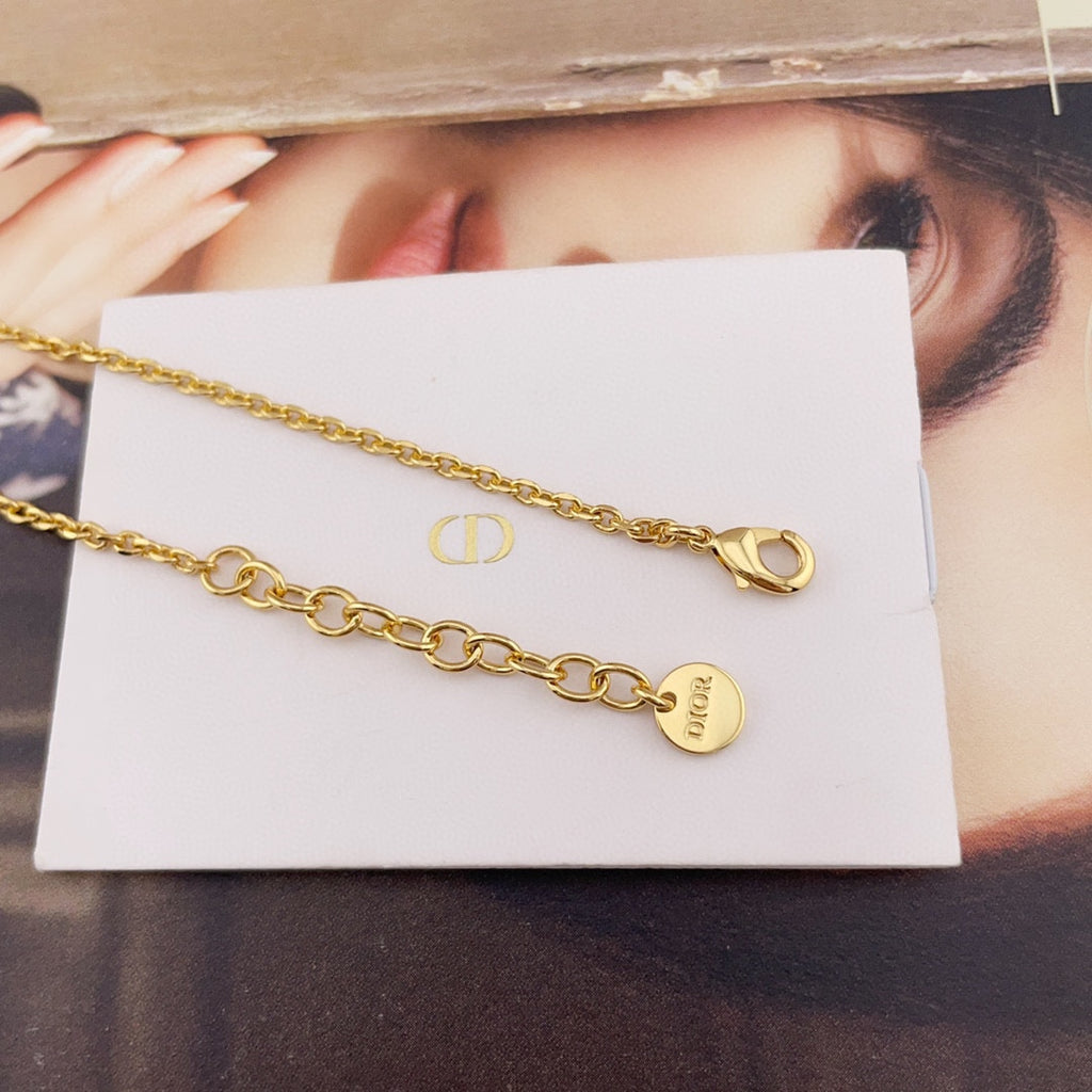 Gold chain necklace with Dior tag and round pearl charm