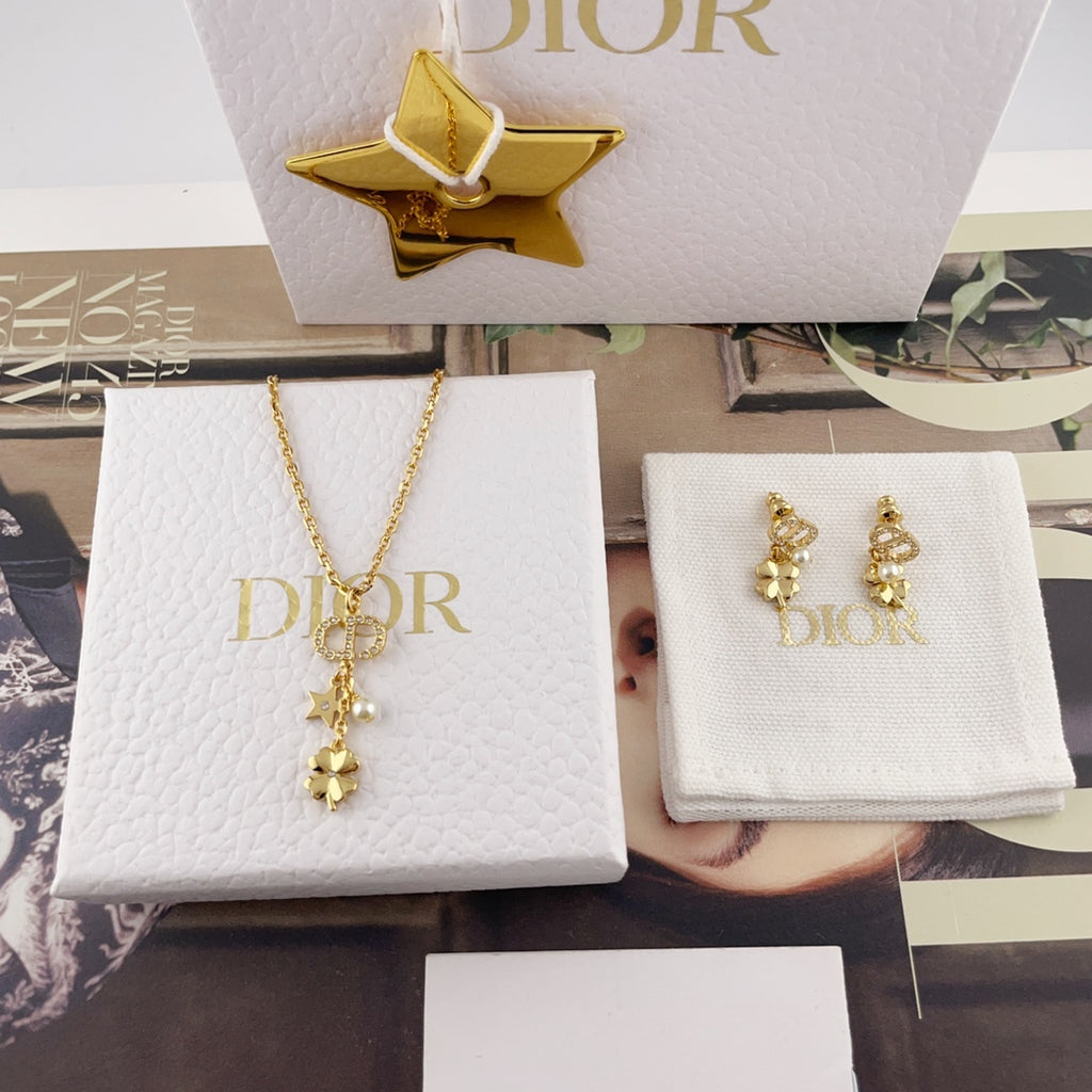Gold Dior charm necklace with star and flower drops, with matching hoop earrings