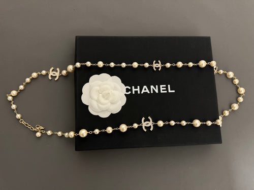 Gold-tone pearl necklace with flower emblem and Chanel logo H accents