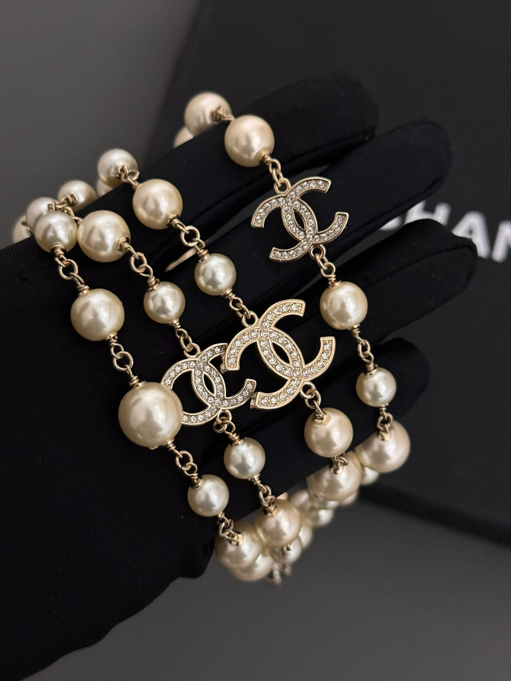 Gold-tone pearl drop earrings with Chanel CC logo and hanging pearl beads
