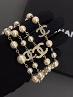 Gold-tone pearl drop earrings with Chanel CC logo and hanging pearl beads