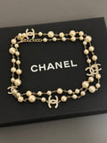 Gold-tone pearl necklace with Chanel logo charms and round bead stations