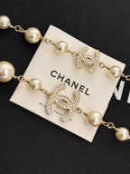 Gold-tone pearl bracelet with Chanel logo CC heart charms and rhinestone details