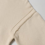 Light beige knit sweater seam detail on side of sleeve and body