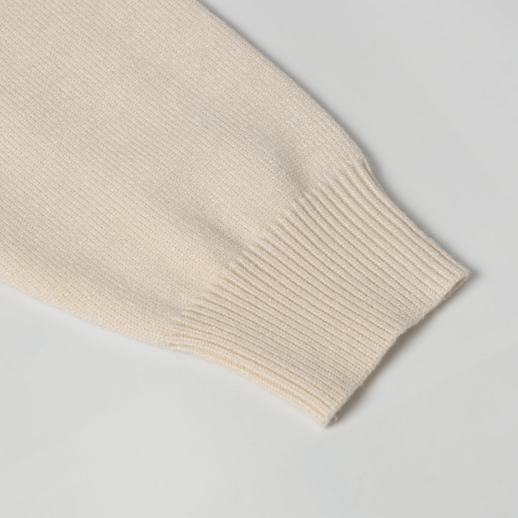 Light beige ribbed knit sleeve cuff with folded edge detail