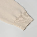 Light beige ribbed knit sleeve cuff with folded edge detail