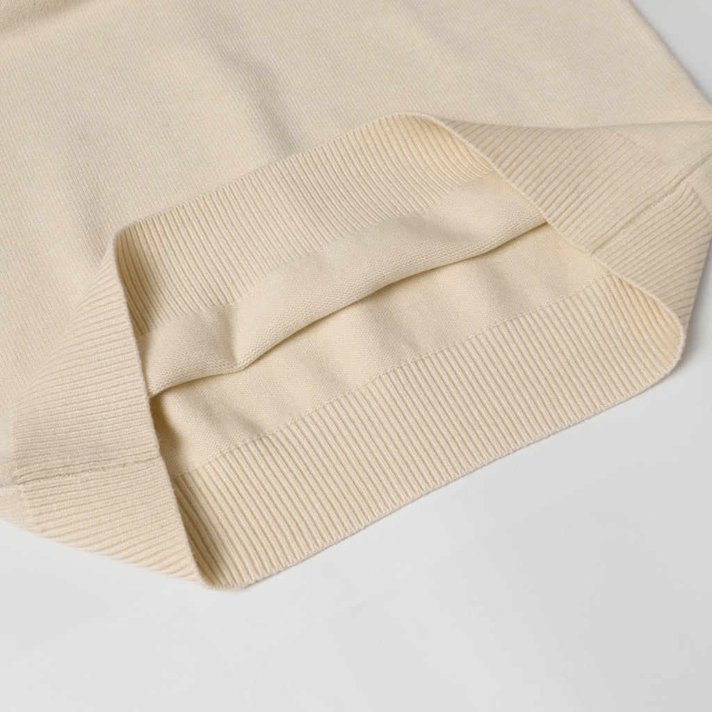 Light beige knit sweater cuff with ribbing and folded sleeve hem