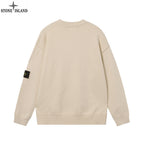 Light beige crewneck knit sweater with ribbed hem and sleeve badge, back view
