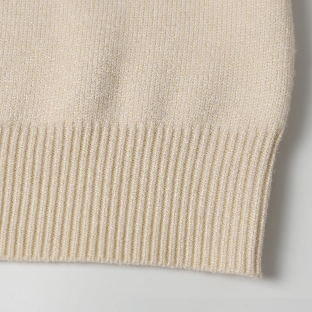 Light beige knit fabric and hem ribbing detail on sweater bottom