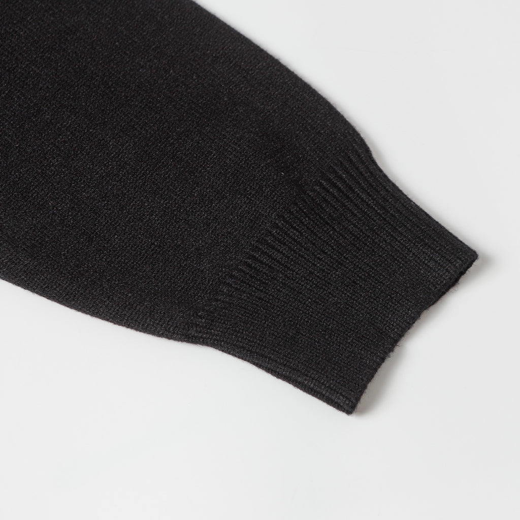 Black knit sweater ribbed sleeve cuff