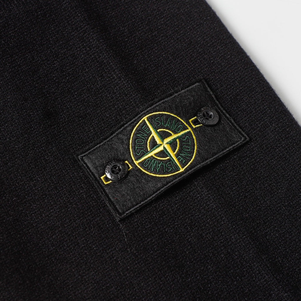 Black knit sweater chest patch with yellow Stone Island logo