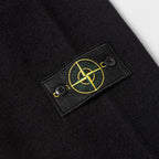 Black knit sweater chest patch with yellow Stone Island logo