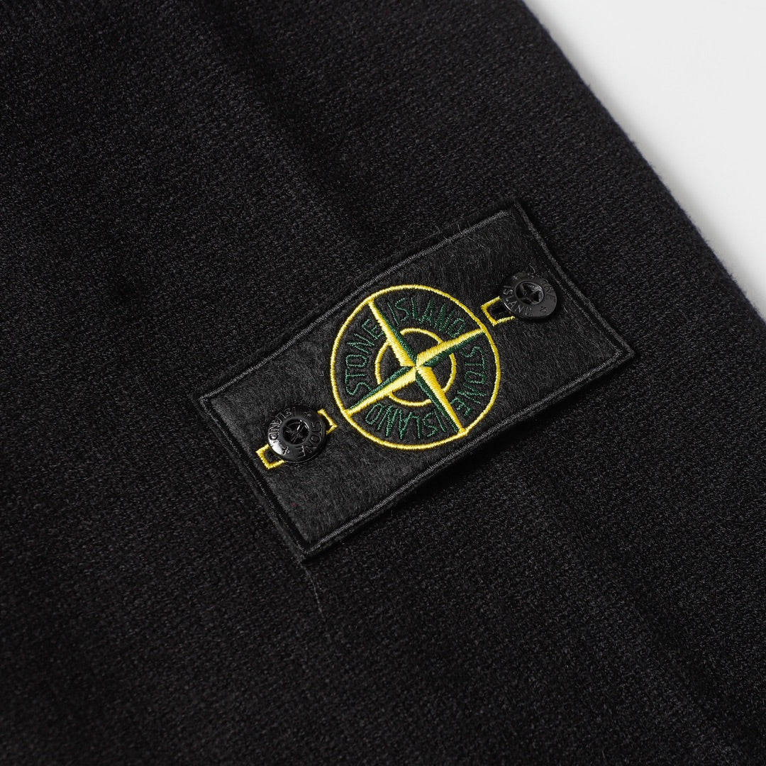 Black knit sweater chest patch with yellow Stone Island logo