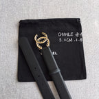 Black belt with gold CC buckle, pouch bag behind the strap