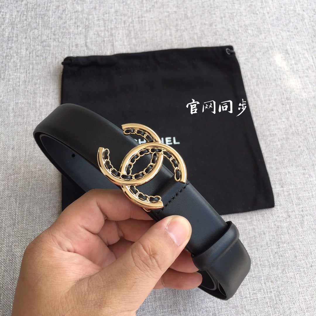 Black belt with gold CC logo buckle, held in hand over a pouch