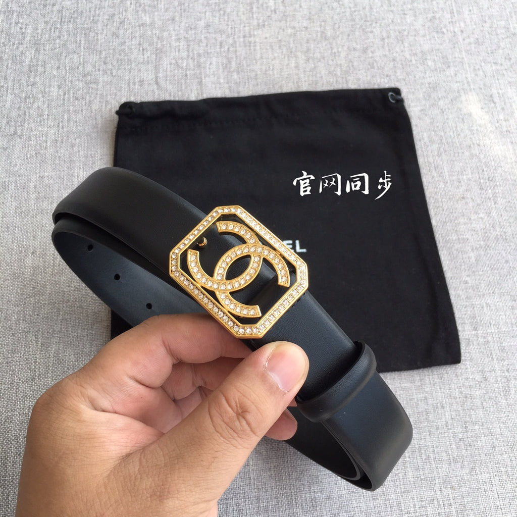 Dark leather Chanel belt with gold square logo buckle, rhinestones, and punched adjustment holes.